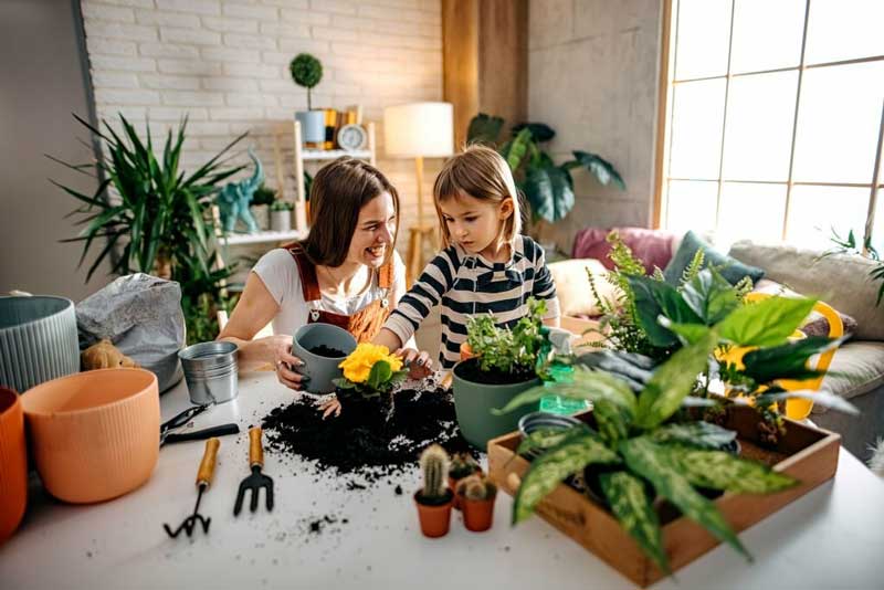 mother and daughter are indoor gardending